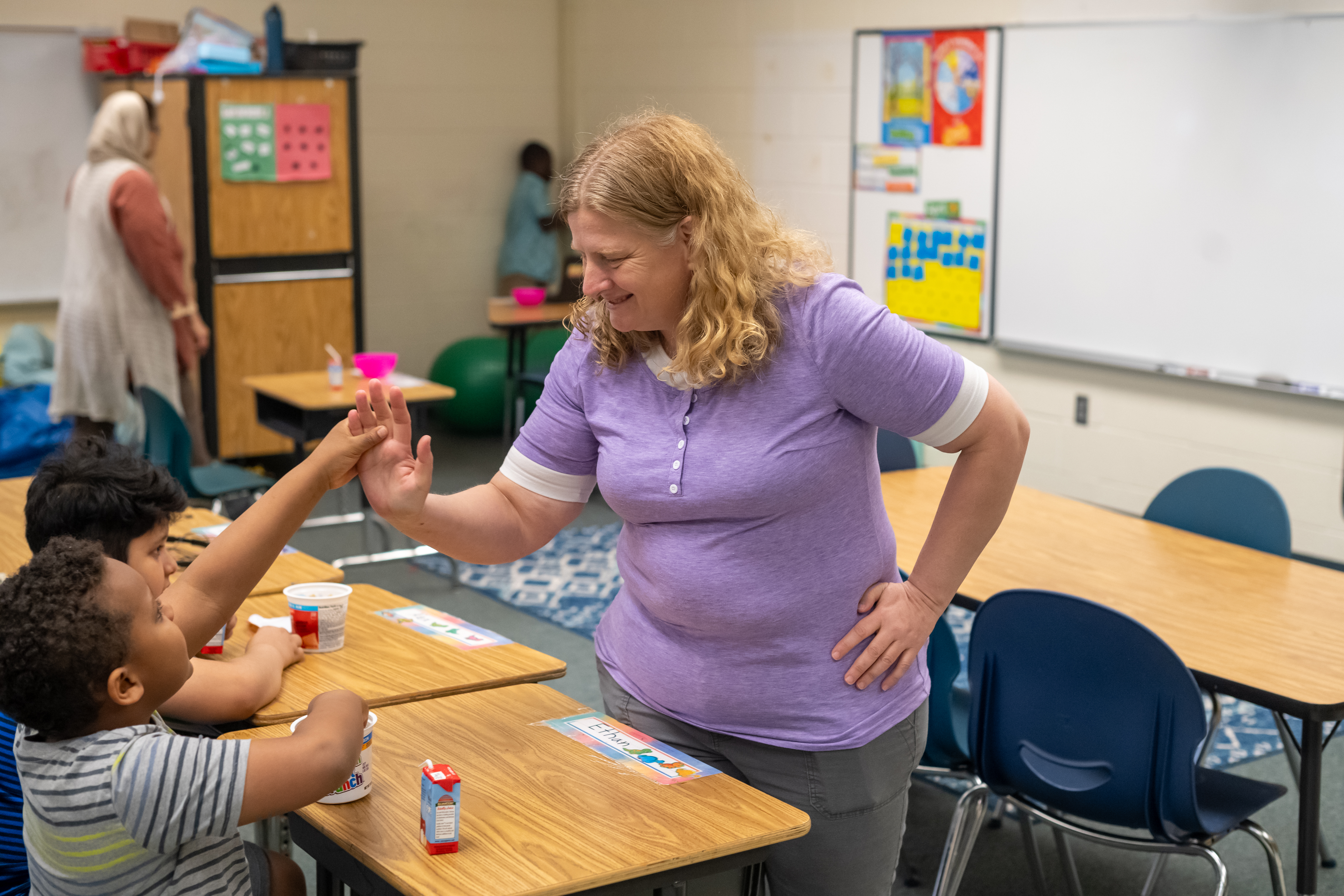 teacher high 5ing a student