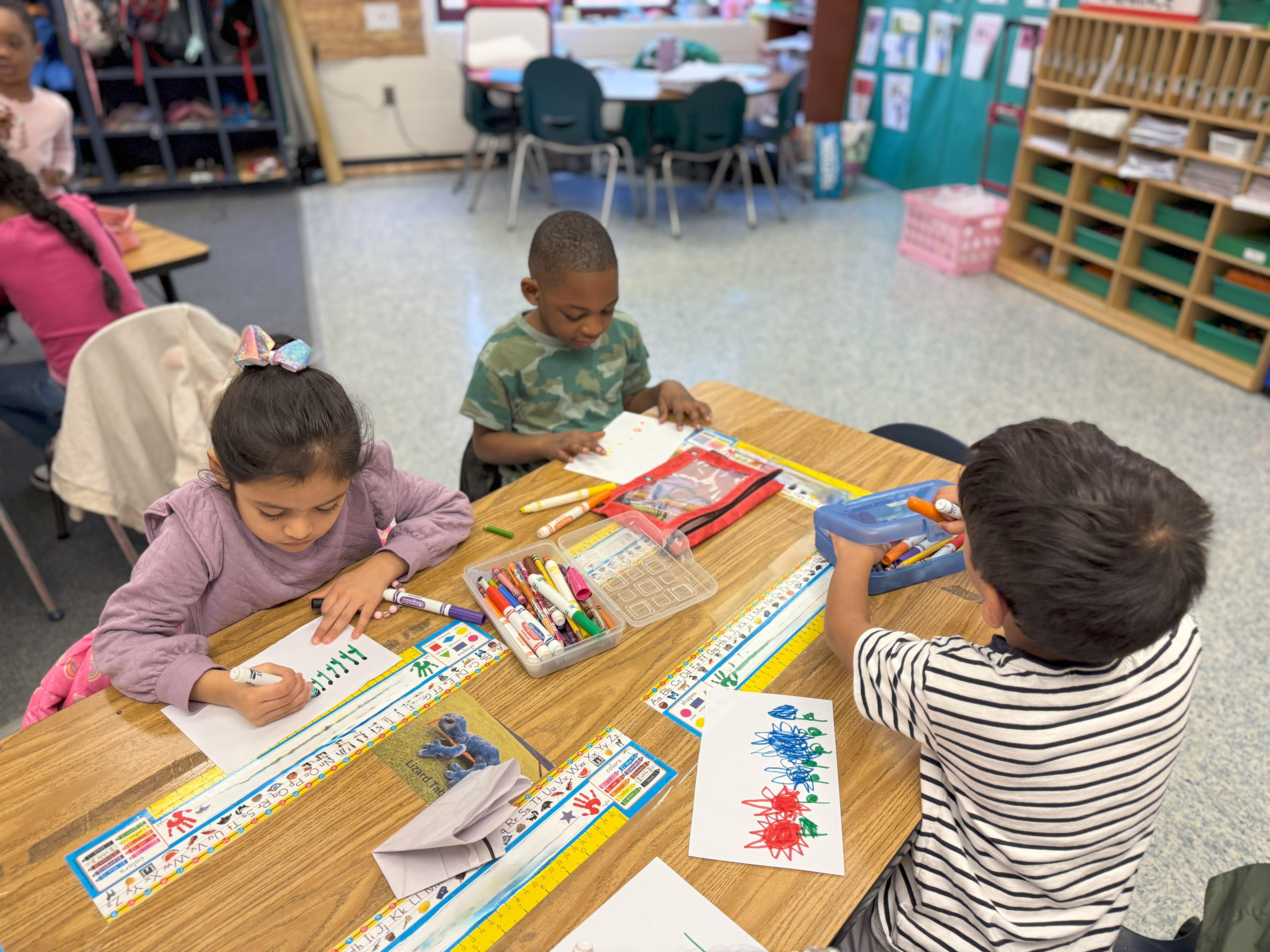 kindergarteners creating picture representations of math word problems